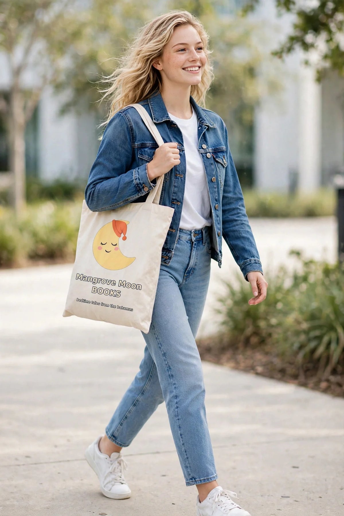 Woman carrying the Mangrove Moon Books Sleepy Luna canvas tote bag